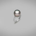 A BUNDA 'Tanara' Cultured Tahitian pearl and diamond ring in platinum, featuring a button shaped pearl, set on a base of threadset round brilliant cut diamonds, fitted to a band, also with threadset round brilliant cut diamonds.  The tahitian pearl is grey/green with pink tones in colour, measures approximately 14.80mm, has a clean skin and an excellent lustre.  Characteristics of diamonds: 40 = 1.15ct, F colour, VS clarity.  Total weight: 8.56g
