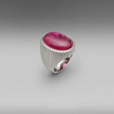 A BUNDA 'Corvus' ring in 18 carat white gold, set with a cabochon cut Tourmaline, surrounded with a line of thread set diamonds. The white gold setting has an elegant brushed finish.  Weight of Tourmaline: 1 =24.15ct.  Characteristics of diamonds: 45 = 0.25ct, F colour, VS clarity.  Total weight: 21.38g