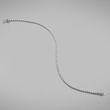 A BUNDA 'Tennis' bracelet in 18ct white gold. The bracelet is set with round brilliant diamonds in castle claw settings. Bracelet is stamped 'BUNDA'.  Characteristics of Round Brilliant Cut Diamonds: 87 = .69ct, F colour, VS Clarity  Total weight of bracelet: 5.19 grams