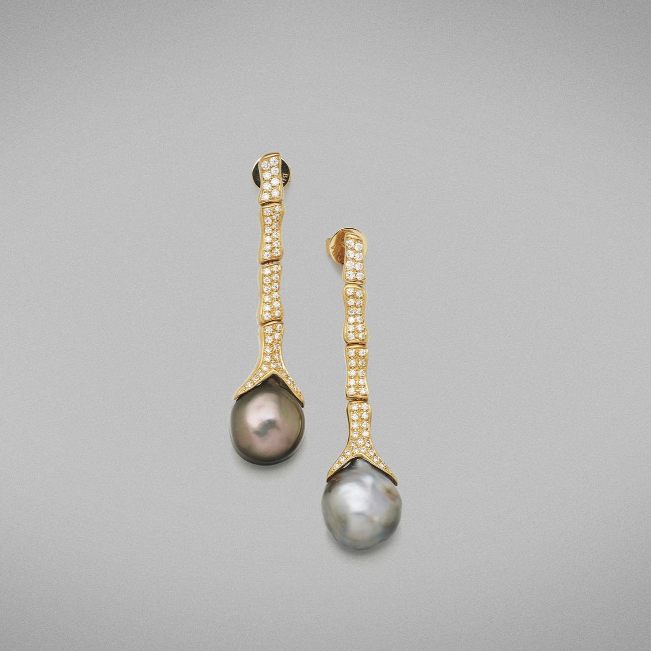 Each earring is set with a baroque shaped keshi pearl with clear skin and excellent lustre. Every ‘Caelum’ link is pave set with round brilliant diamonds and is articulated. Earrings are fitted with posts and butterflies.  Total diamond weight = 0.61ct.  Total weight of earrings = 15.92 grams