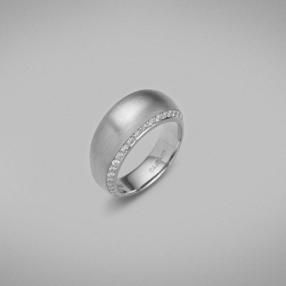 A BUNDA 'Bundova' Diamond Ring in Platinum. The ring has a high dome lined with thread-set round brilliant diamonds on both sides. Ring is stamped 'BUNDA'.  Characteristics of Round Brilliant Cut Diamonds: 50 = 0.49ct, F Colour, VS Clarity  Total weight of Ring: 15.01 grams