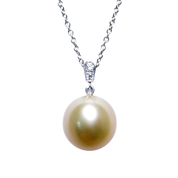 A BUNDA Cultured South Sea pearl and diamond 'Russe' pendant in 18 carat white gold, featuring a drop shaped golden pearl of clean skin and excellent lustre, on an 18 carat white gold Trace chain. Dimensions of pearl: 10.49 - 10.57mm Characteristics of diamonds: 2 = 0.03ct, F colour, VS clarity.