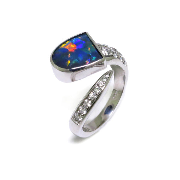 A Superb Australian Black Opal, with excellent play of colour, bezel set in 18ct white gold with pave and thread set diamonds in a wrap setting.  The Opal weighs 1.56ct, features colours of blue, green and strong reds and originates from Lightning Ridge, Australia.  Characteristics of additional diamonds: 20 = 0.68ct, F colour, VS clarity.  Total weight of Ring: 8.80 grams